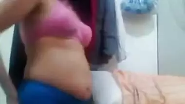 Alluring Indian woman in a yellow sari makes a XXX show of her body