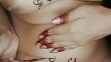Nude girl puts henna on her naked body during a video call sex