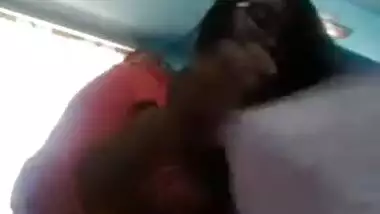 Smiling Indian with glasses listens to music and undresses at once