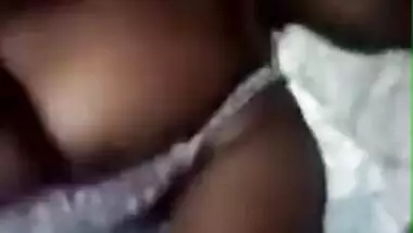 Tanned Desi girl lies in bed stripping XXX boobies for old pervert